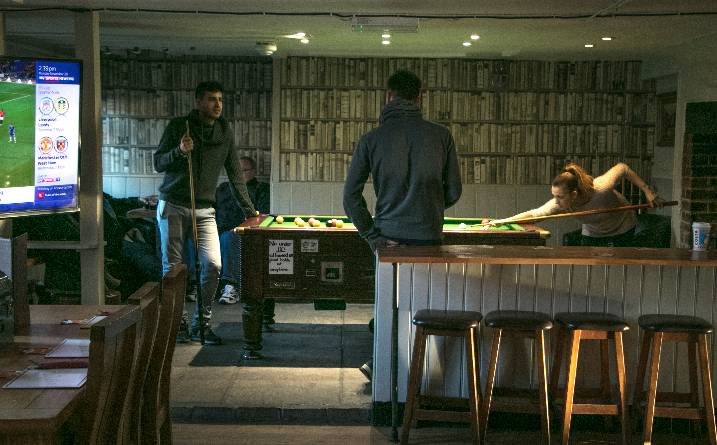 Pool table and players